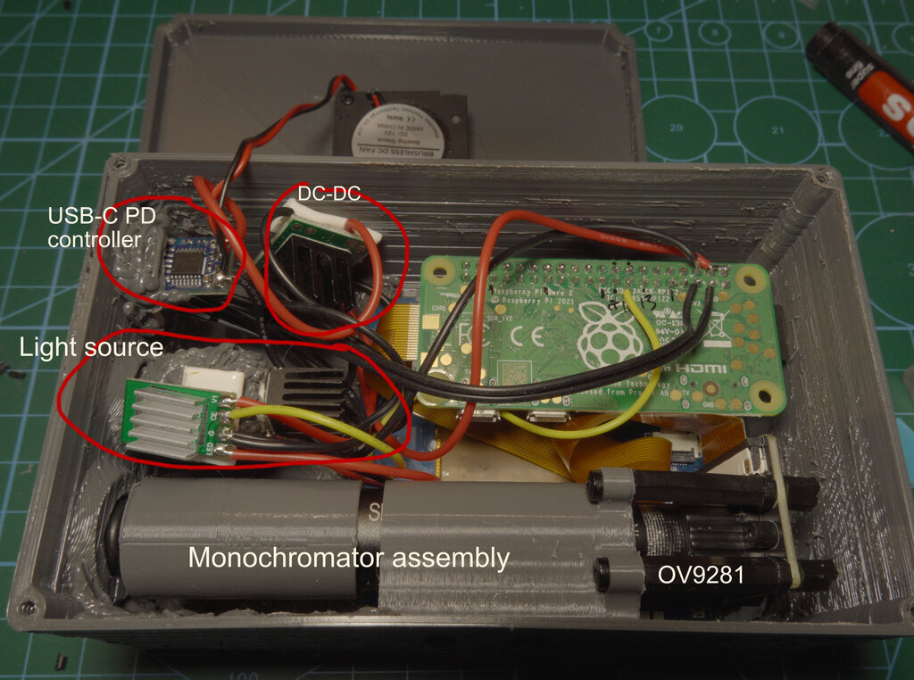 Interior view showing the final assembly with PD board, DC-DC converter, current controller, LED assembly with heatsink, and camera mounting visible
