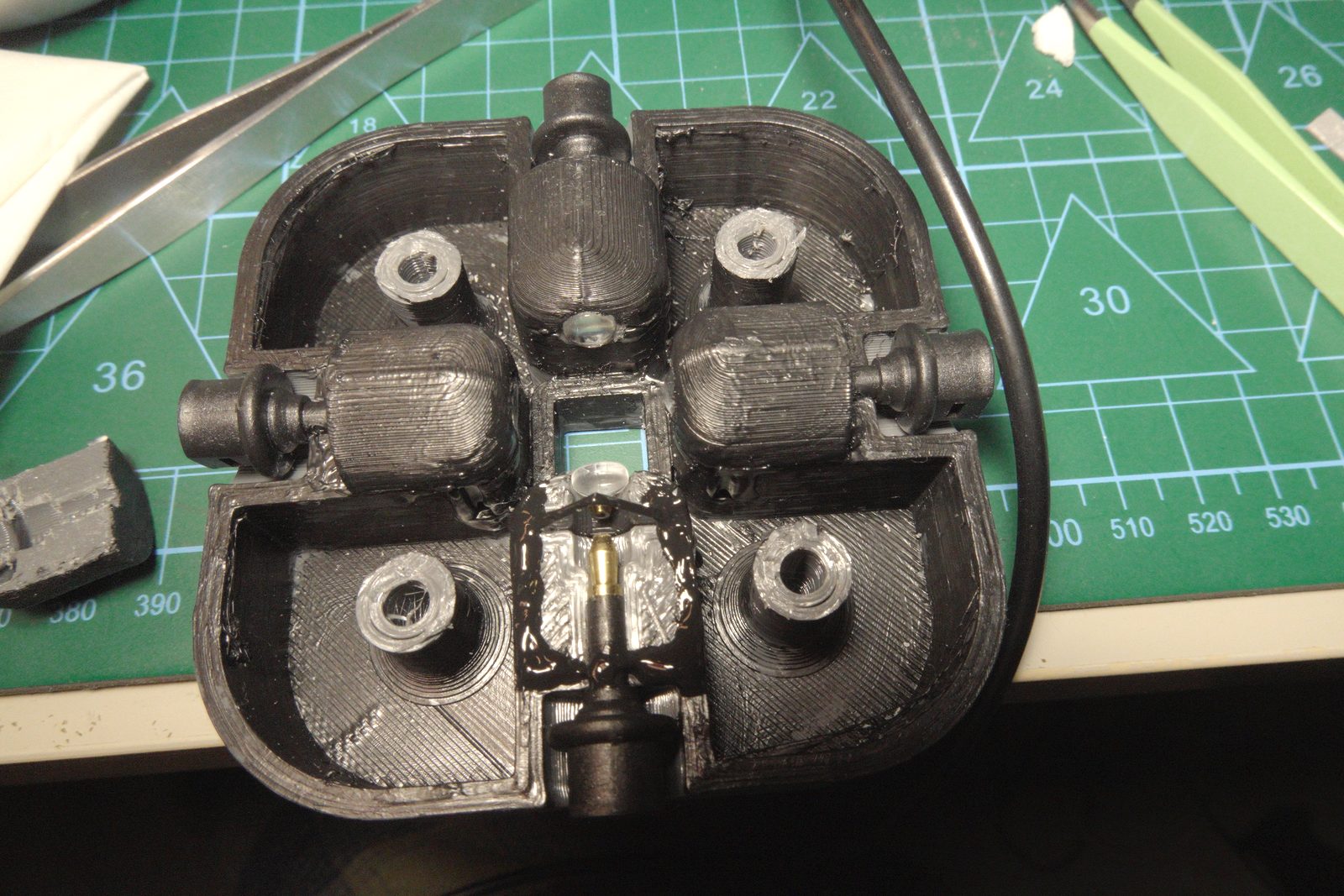 3D-printed cuvette holder — top view showing four collimated TOSLINK ports and center cuvette aperture