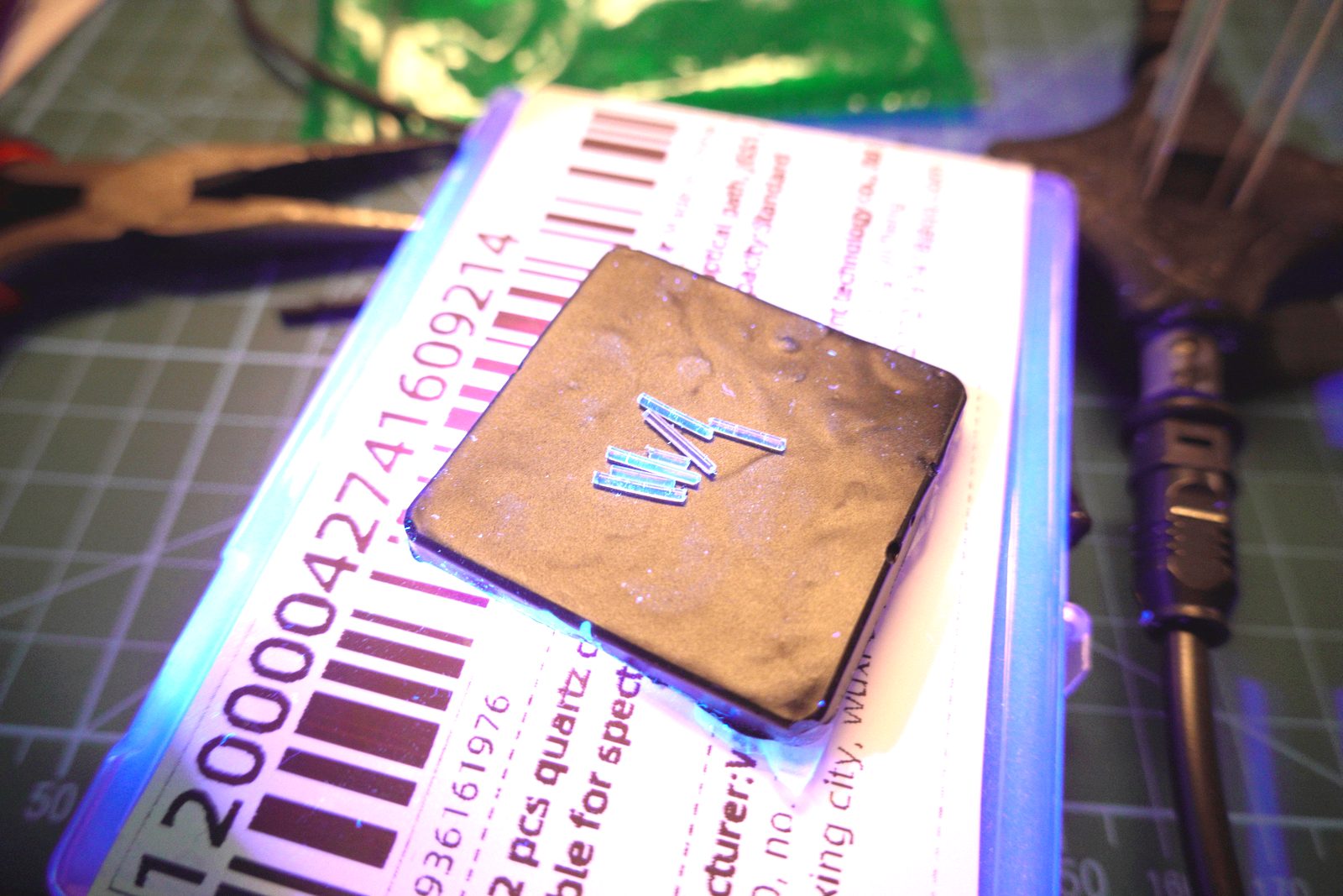 TOSLINK fiber cuts under UV illumination, glowing faint blue-white
