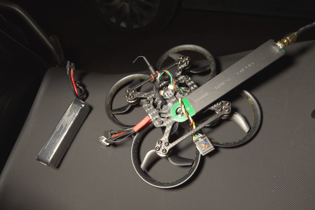 Pavo20 Pro II with VTX removed — TinySA short-wire probe attached near the stack for RF noise measurement