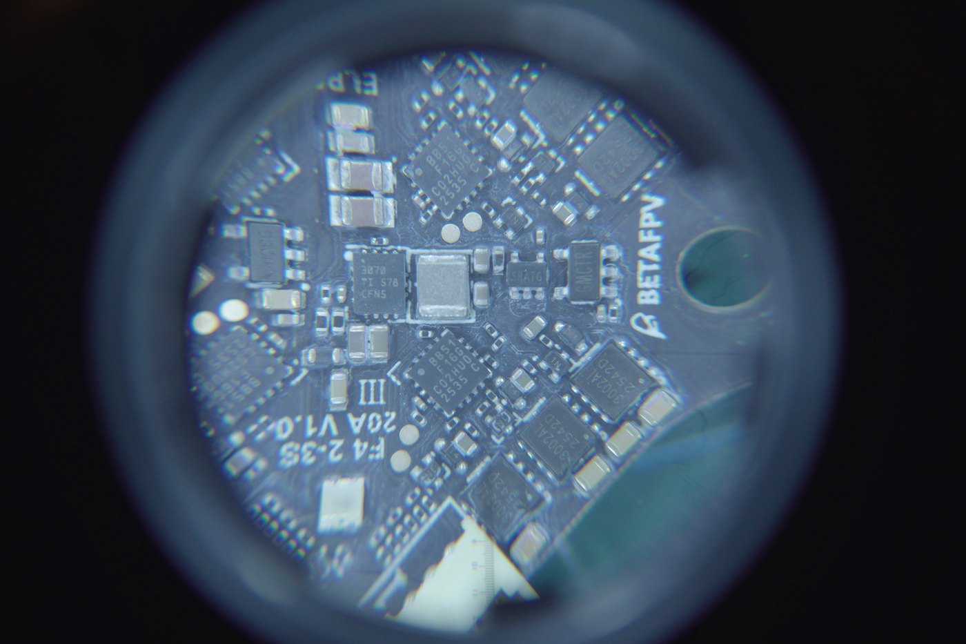 The BetaFPV board under a loupe